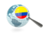 Colombia. Magnified flag with blue globe. Download icon.