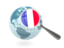 Сен-Бартелеми. Флаг под увеличительным стеклом с голубым глобусом. Скачать иконку.