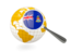 Cayman Islands. Magnified flag with globe. Download icon.