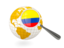Colombia. Magnified flag with globe. Download icon.