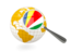 Seychelles. Magnified flag with globe. Download icon.