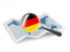 Germany. Magnified flag with map. Download icon.