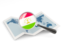 Таджикистан. Флаг под увеличительным стеклом над картой. Скачать иконку.