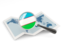 Uzbekistan. Magnified flag with map. Download icon.